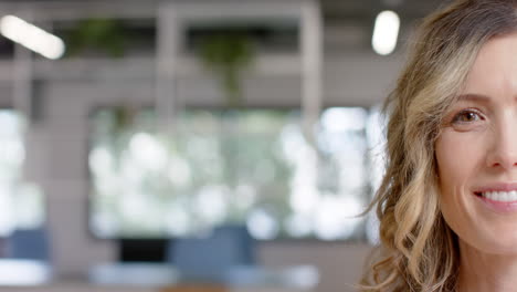 half portrait of happy caucasian casual businesswoman in office with copy space, slow motion