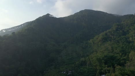 Aerial-sunrise-view-over-mountain-forest-in-foggy-weather