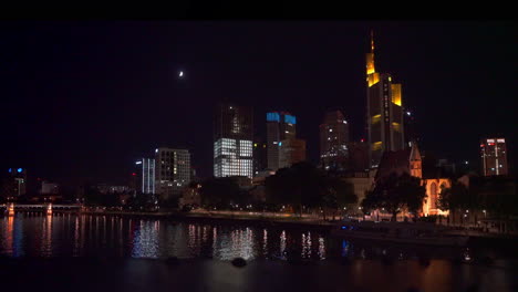 frankfurt, germany skyline and moon framed by bridge