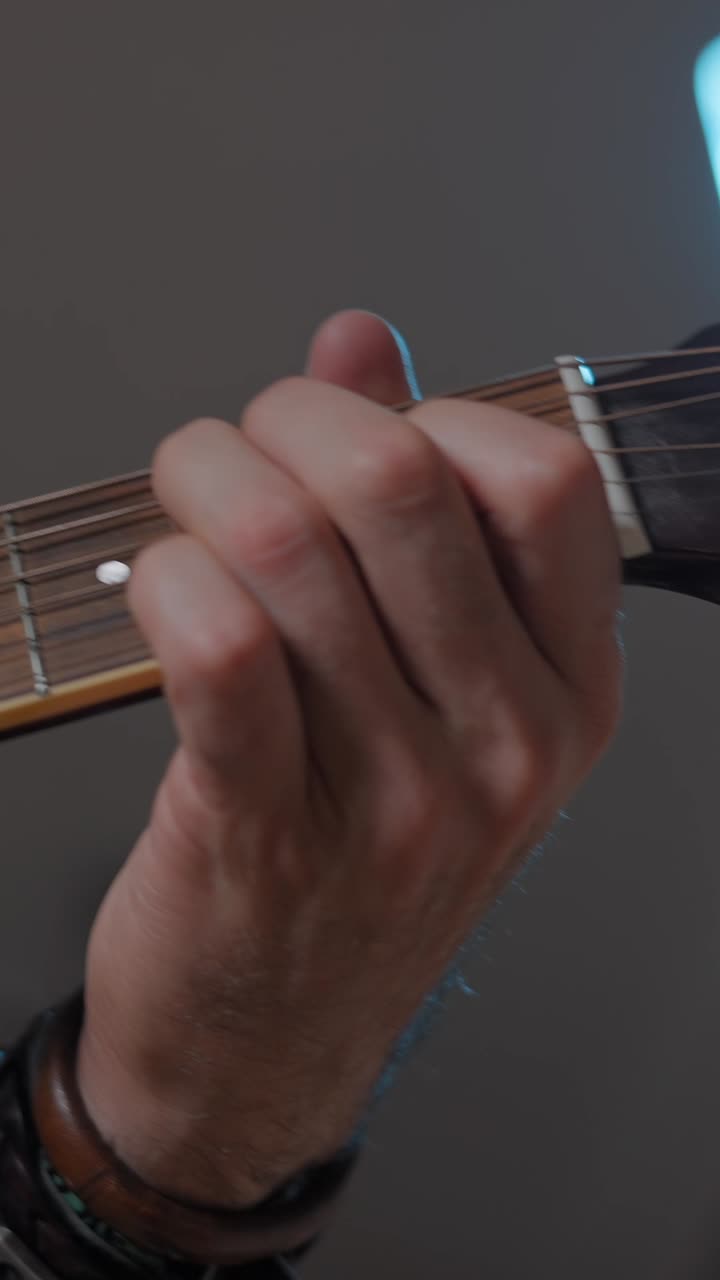 Close-up of hand playing guitar