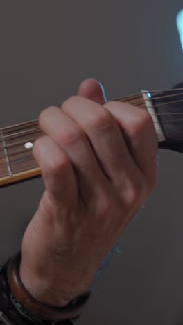close-up of hand playing guitar