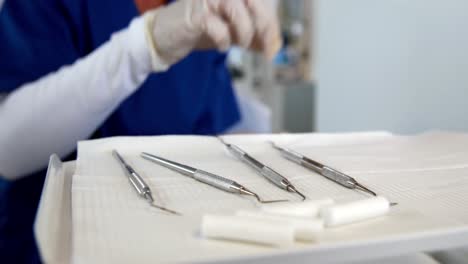 smiling dentist preparing dental tools