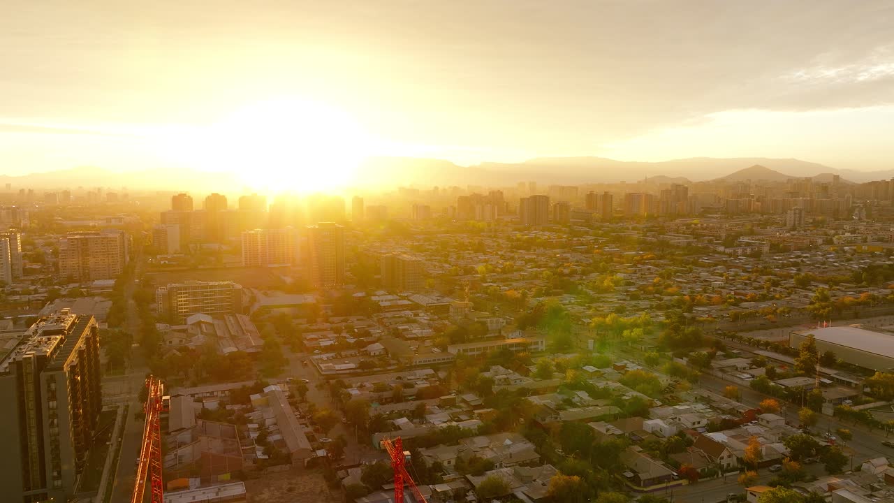Vista aérea do pôr do sol dourado no horizonte com vista para a paisagem urbana de Santiago, no Chile.