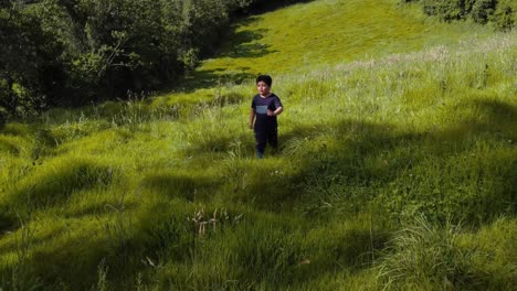 a joyful little kid dashes across the green grass with pure excitement and energy