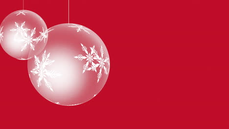 White-hanging-Christmas-balls-with-snowflakes-inside-on-red-gradient