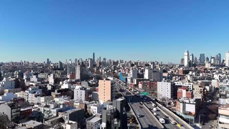 horizontal drone ascending shot over withers street in brooklyn, capturing the city's vibrant streets, residential rooftops, and dynamic skyline as the camera smoothly rises.