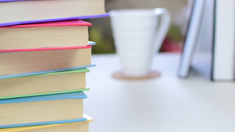 desk with stack of study books. textbooks for the student, university. study from home. distance education concept.
