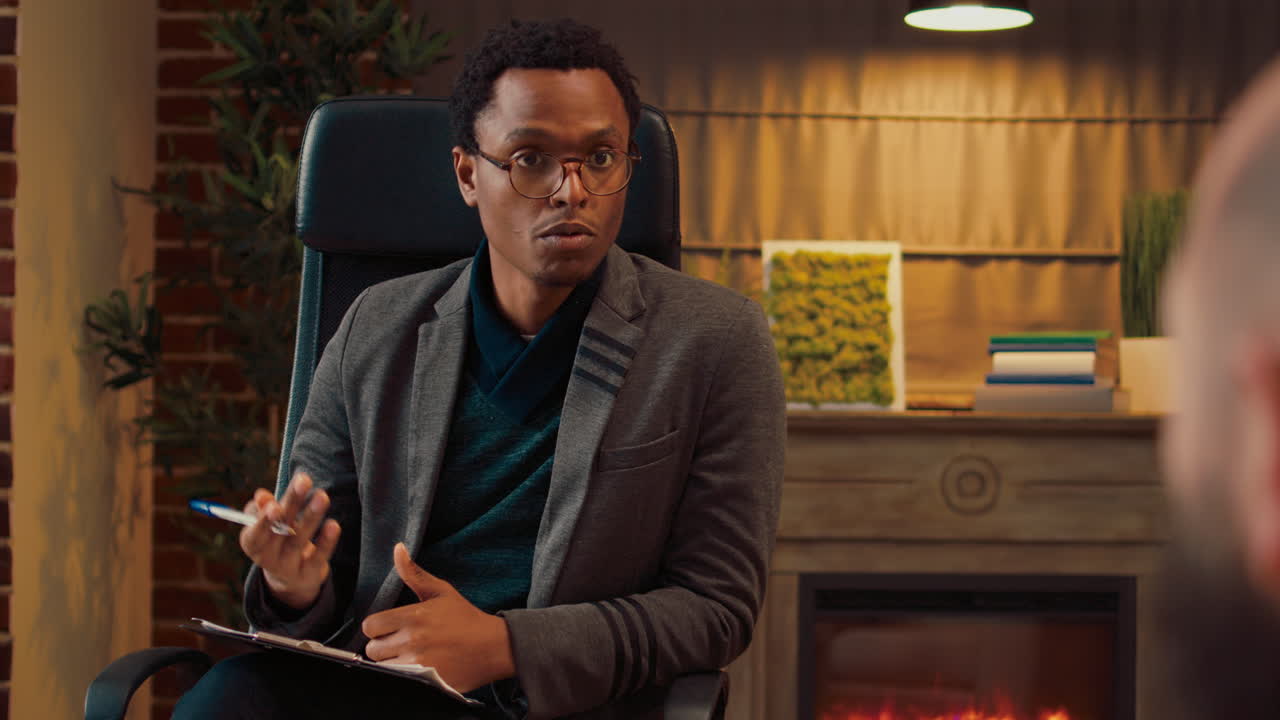 Male counselor giving relationship advice to unhappy couple