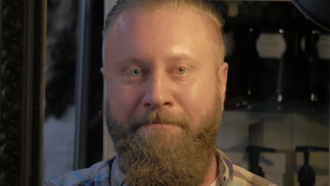 view of bearded bald man smiling and showing thumbs up