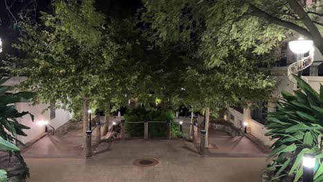 Date-night-walkway-at-night-with-leaves-leading-down-to-water-of-East-Perth,-Claisebrook-Cove