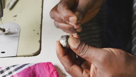 african man preparing the thread for sewing