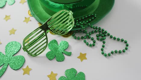 shamrocks and stars with green hat and glasses with copy space on white background