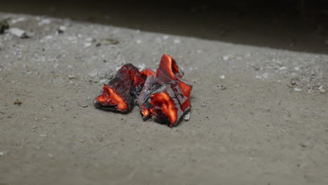 embers on the concrete in front of the fireplace