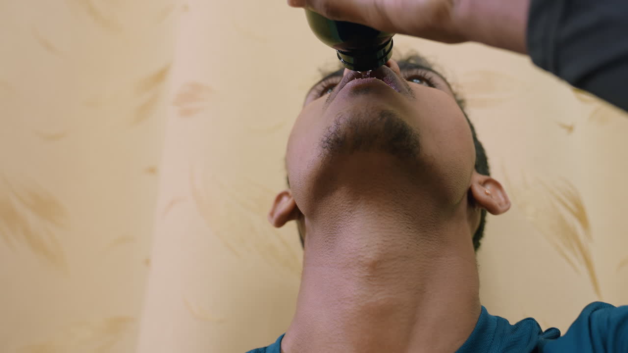 Close up of athlete lifting bottle to drink water after intense training, focusing on hydration, recovery, refreshment, and endurance, emphasizing importance of discipline, health