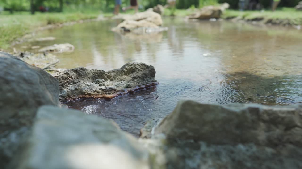 Panning from the left to the right side of the frame, showing the flowing and bubbling thermal hot springs located in St. Petka, in the town of Rupite, Petrich, Bulgaria.