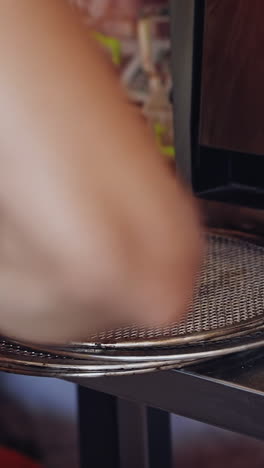 pizza is ready. pizzeria master making pizza. chef pulling pizza out of the oven using the pizza spatula. cook puts the finished pizza on the plate. tasty pizza. vertical video