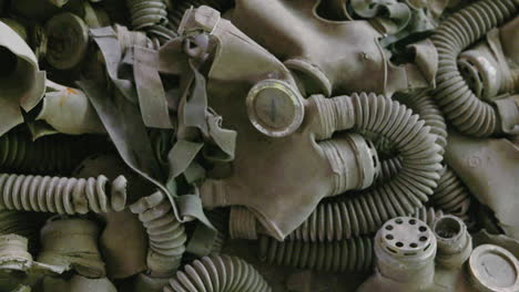 a pile of gas masks on the floor inside the abandoned school in chernobyl exclusion zone, ukraine