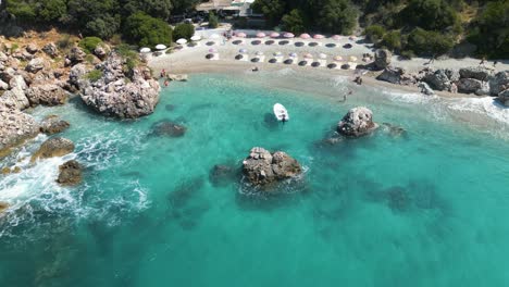 Turquoise-green-clear-ocean-water-waves-crash-on-beautiful-tropical-resort-beach