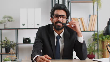 businessman working on laptop wearing headset, call center support service operator office helpline