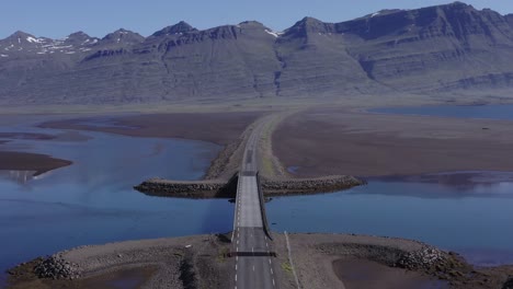 Low-tide-at-bridge-crossing-river-in-Breiðdalsvík-fjord,-East-Iceland