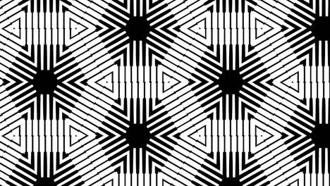 black and white symmetrical designs transition over black background - closeup, slow motion