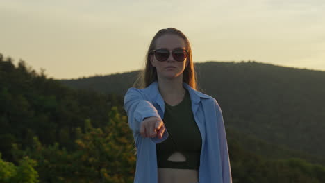 young woman pointing at you