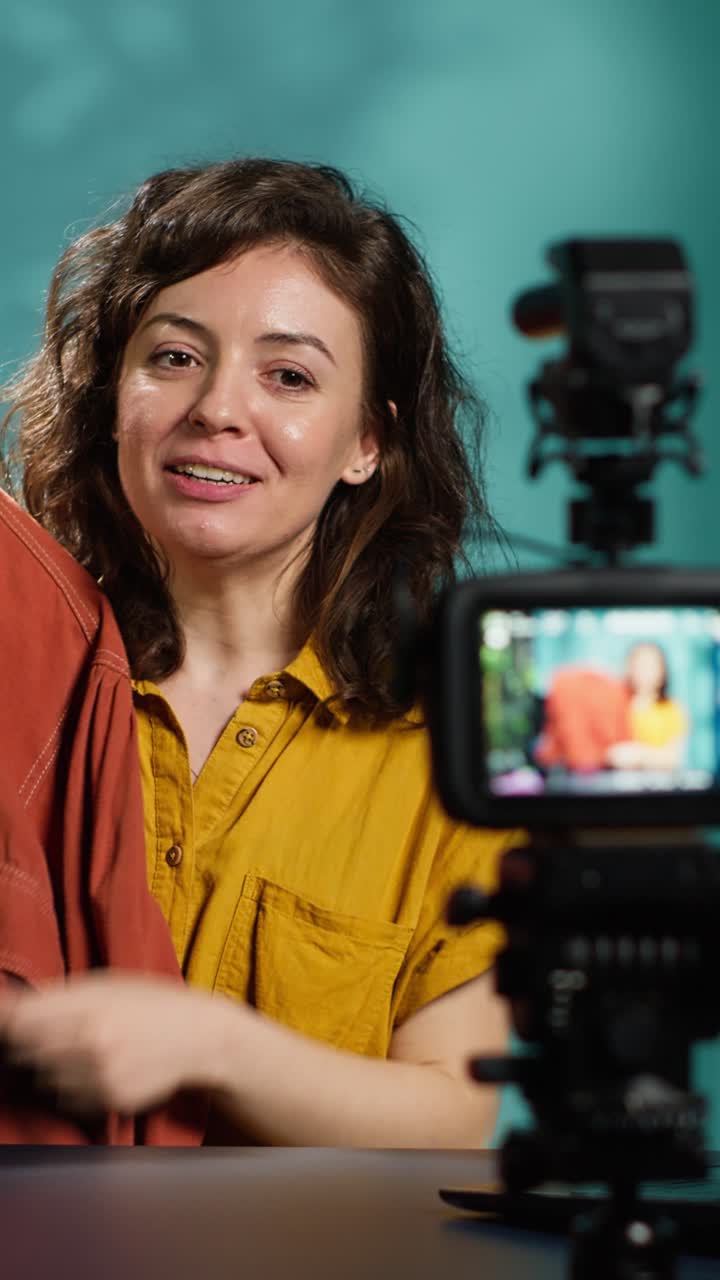 Woman Vlogger Recording Fashion Review Video with Clothing Item
