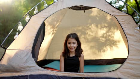 smiling girl in a camping tent