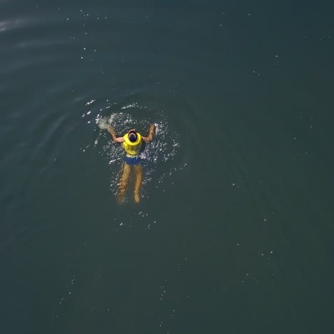 little boy swimming in the lake. happy children on summer vacation. aerial view.