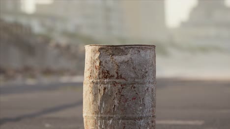 old rusty metal barrel on the street