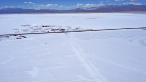 Wide-forward-aerial-of-people-at-enormous-salt-flats-in-Argentina