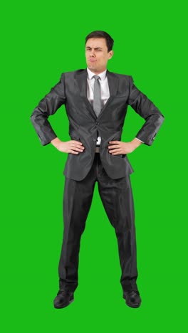 businessman in suit on green screen displaying expressions of discomfort, disdain, or arrogance
