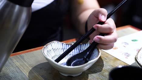 person pouring water into a bowl