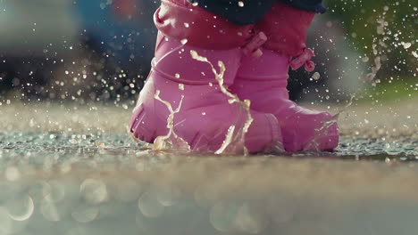 child in pink rubber waterproof boots