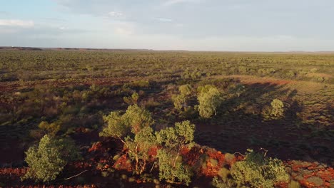 flying over the edge of an abandoned mine to reveal pristine outback bushland