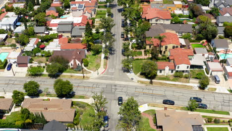 aerial view of a suburban residential neighborhood with houses and tree-lined streets
