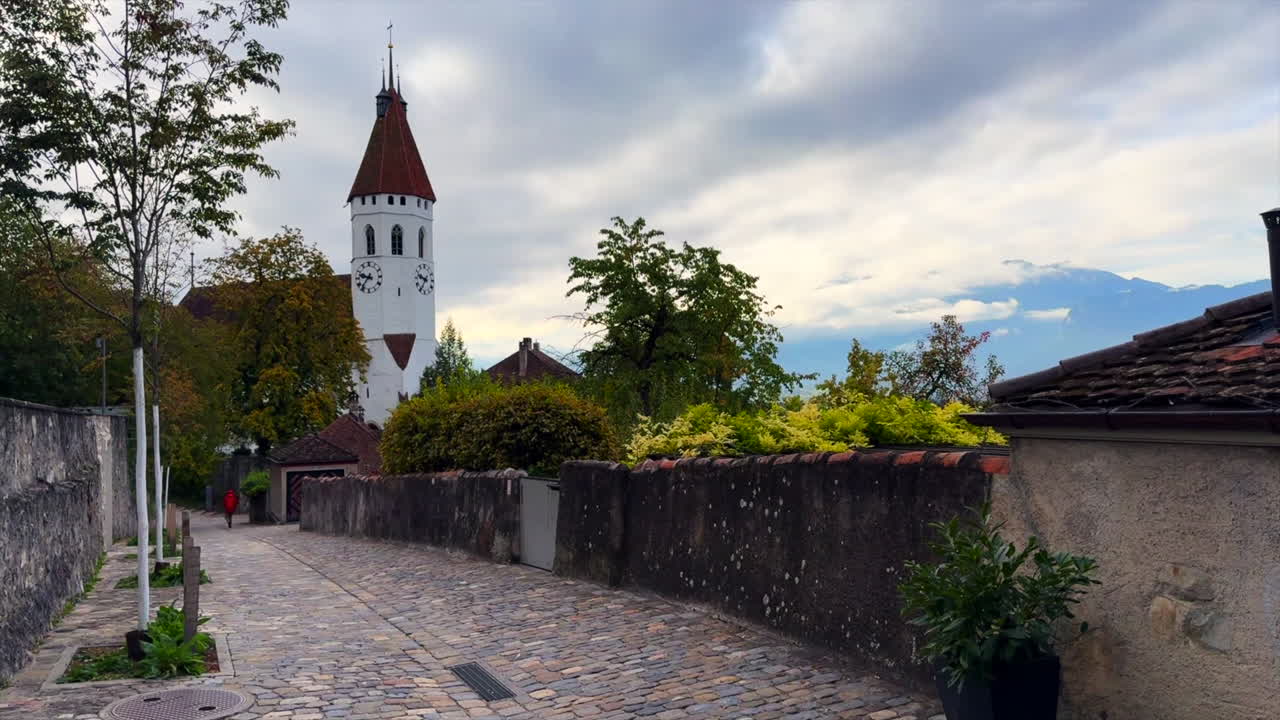 Thun Castle Schlossberg Swiss Alps Switzerland historic site clock tower walkway cloudy morning beauty landscape summer fall autumn city Bern Interlocken Aare Thunersee slow cinematic pan left