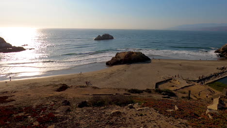 still shot of ocean beach and the sutro baths remains in northern california with the pacific waves crashing into the coastal cliffs on a calm summer night - 4k