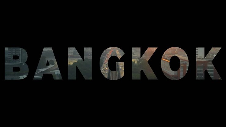 Drone Shot Of Thai City Skyline At Sunset Overlaid With Graphic Spelling Out Bangkok