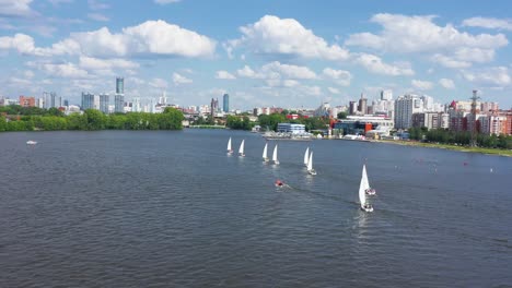 cityscape with sailing boats on a river