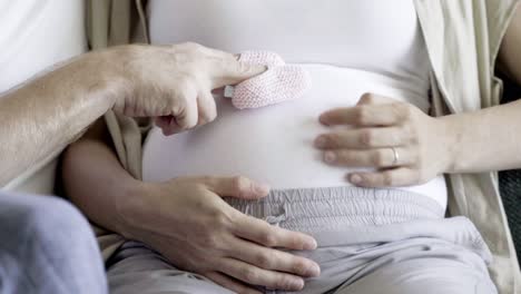 closeup shot of couple sitting and playing with booties