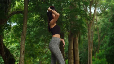 a young girl, clad in sports wear, embraces the active lifestyle in a tropical park