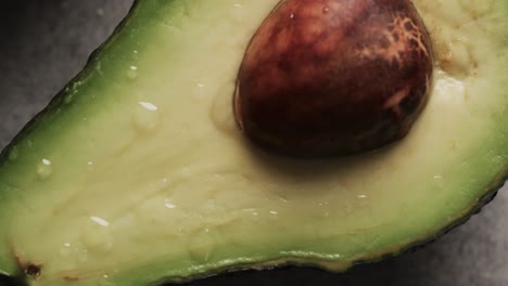 Micro-video-of-close-up-of-avocado-with-copy-space-on-grey-background