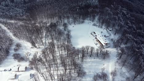 Aerial-winter-panorama:-Chumerna-lodge-amidst-snow-covered-forest-and-majestic-mountains