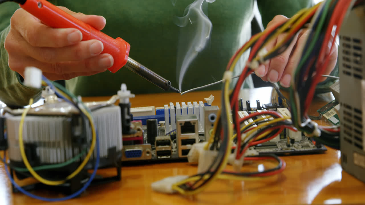 Female electrical engineer soldering a circuit board 4k
