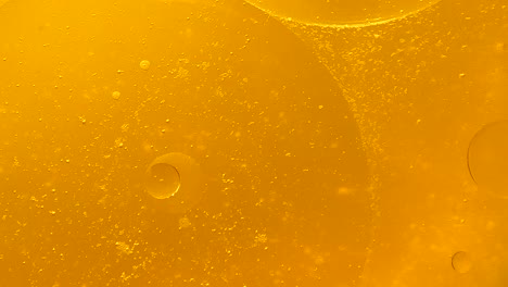 rotating gold oil bubbles background