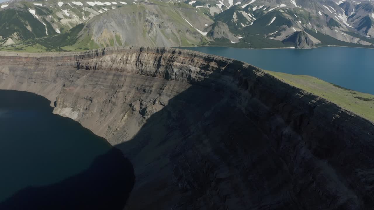 Aerial view of Crater Lake National Park, Oregon, USA, from the rim near Watchman Peak. Sheer volcanic cliffs drop to deep blue waters surrounded by rugged mountain scenery and lush forest slopes