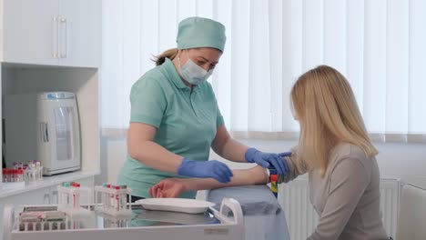 a doctor in a hospital gently draws blood from a girl for diagnostic tests.