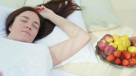 A-Young-Woman-Is-Sleeping-Near-A-Plate-With-Fruit-Bed-And-Breakfast-Romance-And-Honeymoon-Romance-Hd