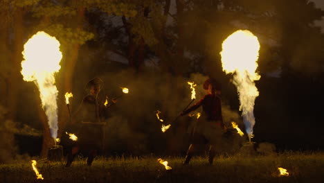 fire jugglers in the forest at night